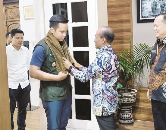 Bupati Kendal periode 2021-2025 Dico M. Ganinduto menerima kalungan kain khas Kendal dari Pj. Sekda Kendal Agus Dwi Lestari dalam kegiatan pelepasan Bupati Kendal di Ruang Paringgitan Setda Kendal, Rabu (19/2). (Arvian Maulana | Mantranews.id)