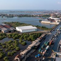 Kendaraan bermotor melaju perlahan menembus jalan raya pantura Demak KM Surabaya-Semarang di Kecamatan Sayung, Kabupaten Demak, Jawa Tengah yang terendam rob. (Lingkar Media Group Network)