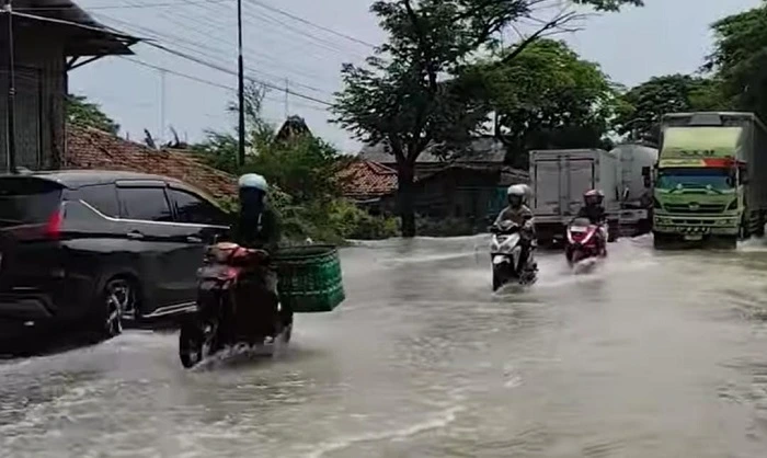 Antisipasi Banjir, DPRD Pati Desak Pemkab dan BBWS Normalisasi Sungai 1 Sejumlah pengendara melintas di genangan banjir di jalur Pantura Pati-Rembang turu Kecamatan Batangan, Senin (27/10/2025)>